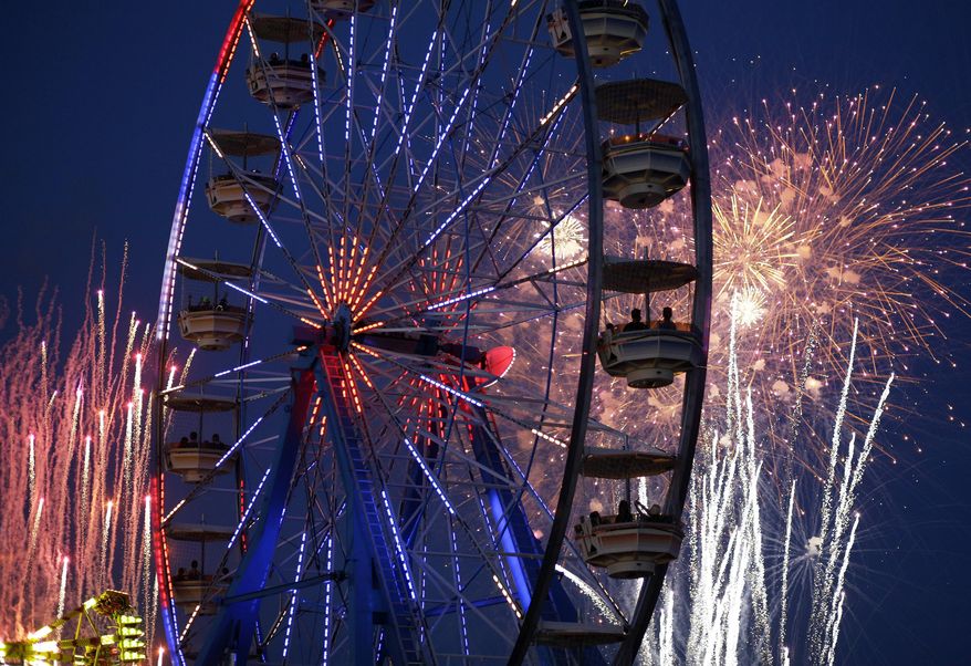 Fireworks explode over the Electric Daisy Carnival, Friday, June 20, 2014, in Las Vegas. Fireworks and rides, including 5 Ferris wheels, add to the carnival atmosphere of the electronic dance music festival. (AP Photo/John Locher)