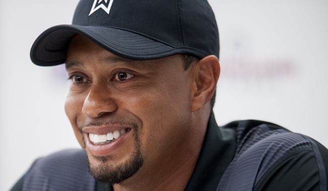 Tournament Host Tiger Woods answers questions from the media during a press conference Tuesday at the Quicken Loans National golf tournament being played at Congressional Country Club in Bethesda, Maryland. (Pete Marovich Special to The Washington Times)