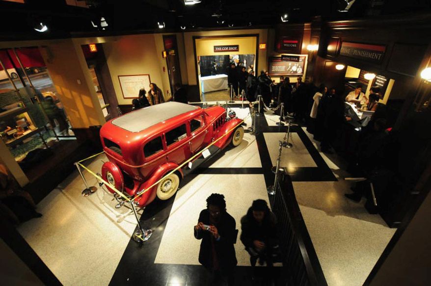 Visitors enter through the lobby of the National Museum of Crime and Punishment in the District. The 28,000-square-foot museum chronicles the history of crime with a number of riveting exhibits. Included is a replica of the pre-Alcatraz jail cell (below) of former mob boss Alphonse "Big Al" Capone. (crime museum photographs)