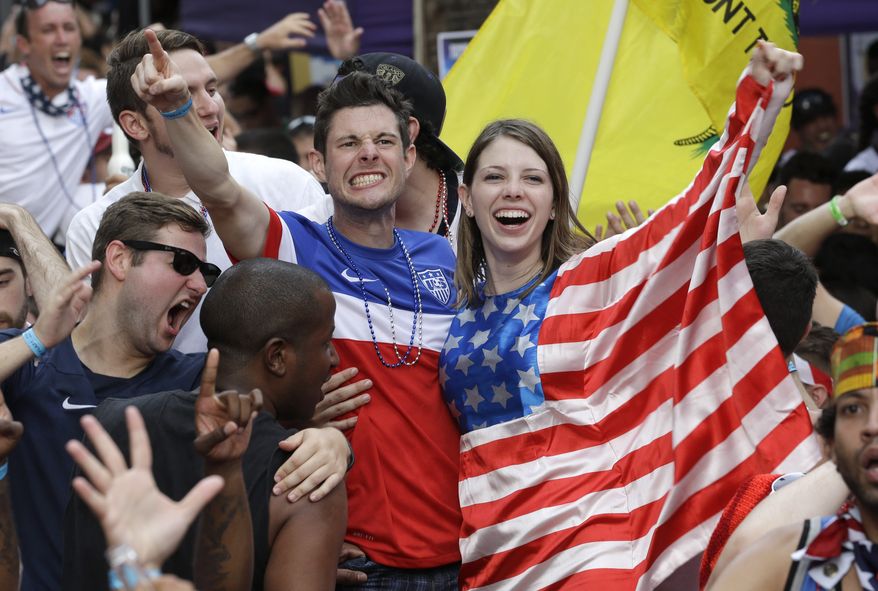 Fans celebrate as the United States scores a goal against Portugal while watching a World Cup soccer match, Sunday, June 22, 2014, in Orlando, Fla. (AP Photo/John Raoux)