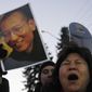 Protesters scream for the freedom of Nobel peace laureate Liu Xiaobo on Thursday, Dec. 9, 2010, outside the Chinese Embassy in Oslo, Norway. (AP Photo/John McConnico)