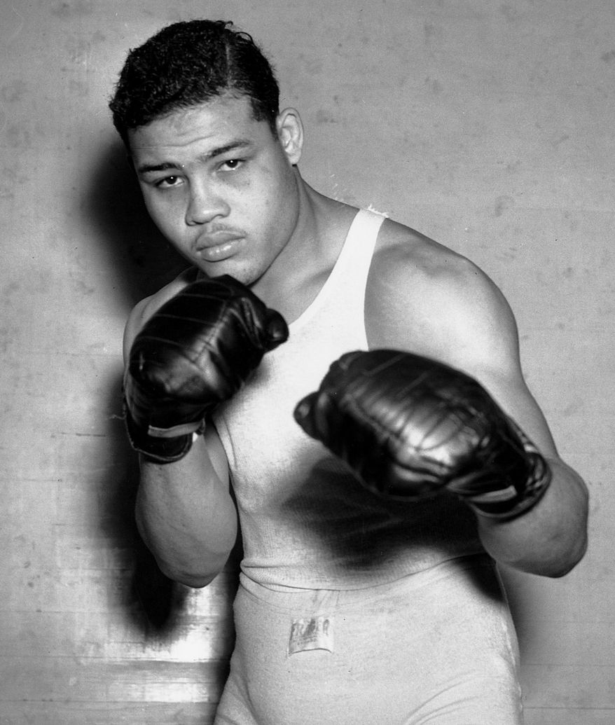 This Jan. 24, 1937 file photo shows boxer Joe Louis, nicknamed the Brown Bomber, posing in Pompton Lakes, N.J. Louis captures the world heavyweight title in June 1937 and held it until May 1949.   (AP Photo/File)  **FILE**