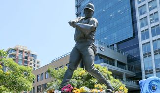 Flowers left in memoriam at the statue of Tony Gwynn in front of Petco Park, San Diego, California            Associated Press photo