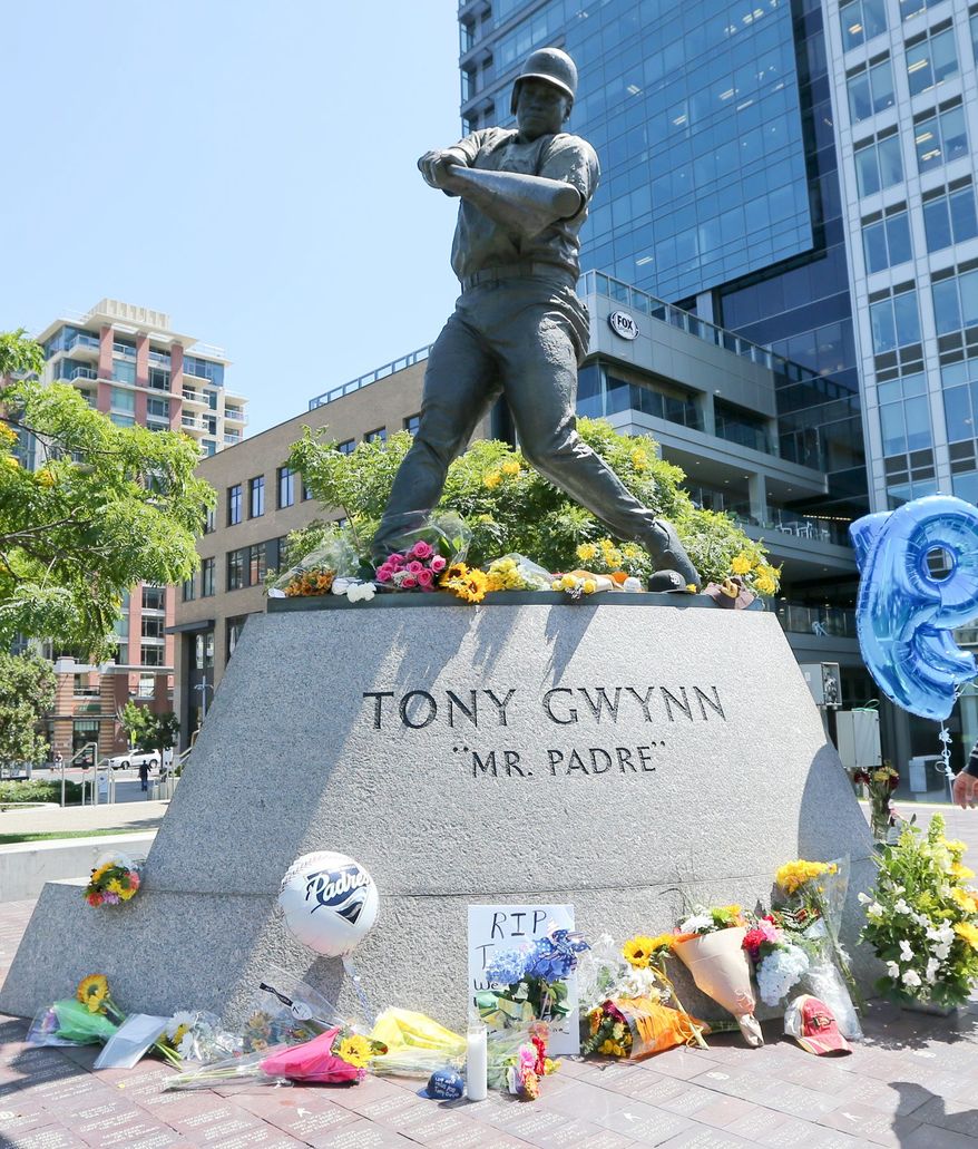 Flowers left in memoriam at the statue of Tony Gwynn in front of Petco Park, San Diego, California            Associated Press photo