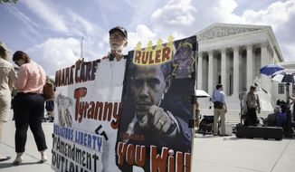 Ronald Brock moves his anti-Obamacare sign as protestors, press and passersby wait for decisions in the final days of the Supreme Court&#x27;s term, in Washington, Wednesday, June 25, 2014. (AP Photo/J. Scott Applewhite) ** FILE **