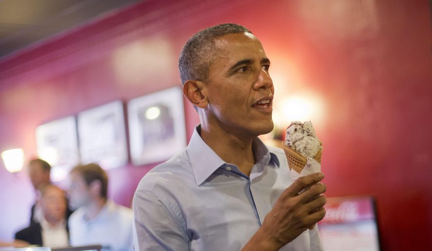 President Barack Obama holds his ice cream cone during a visit to Grand Ole Creamery in St. Paul, Minn., Thursday, June 26, 2014.  (AP Photo/Pablo Martinez Monsivais)