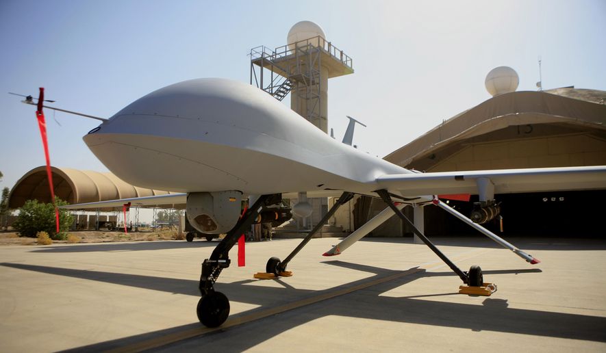 FILE - This June 21, 2007 file photo show a MQ-1 Predator controlled by the 46th Expeditionary Reconnaissance Squadron stands on the tarmac at Balad Air Base, north of Baghdad, Iraq.  A Pentagon official says the U.S. has started flying armed drones over Baghdad to protect U.S. civilians and military forces in the Iraqi capital. The official said the flights started in the last 24 to 48 hours to bolster manned and unmanned reconnaissance flights the military has been sending over violence-wracked Iraq in recent weeks. He spoke on condition of anonymity because he was not authorized to discuss the new flights on the record. (AP Photo/Maya Alleruzzo, File) **FILE**
