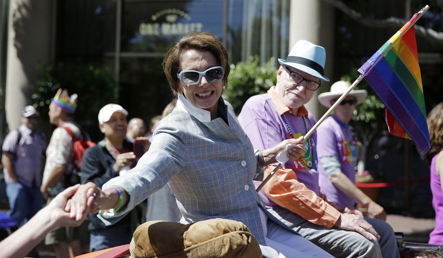 House Minority Leader Nancy Pelosi shakes hands while riding in the 44th annual San Francisco Gay Pride parade Sunday, June 29, 2014, in San Francisco. The lesbian, gay, bisexual, and transgender celebration and parade is one of the largest LGBT gatherings in the nation. (AP Photo/Eric Risberg)