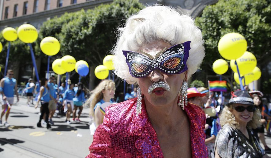 A man dressed in drag marches with a group of employees and family members with Kaiser Permanente during the 44th annual San Francisco Gay Pride parade Sunday, June 29, 2014, in San Francisco. The lesbian, gay, bisexual, and transgender celebration and parade is one of the largest LGBT gatherings in the nation. (AP Photo/Eric Risberg)