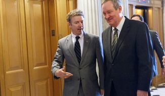 Sen. Mike Crapo (right), Idaho Republican, confers with Sen. Rand Paul, Kentucky Republican. He aims to revamp a $10 trillion mortgage market, the largest piece of unfinished business from the 2008 credit crisis. (Associated press)