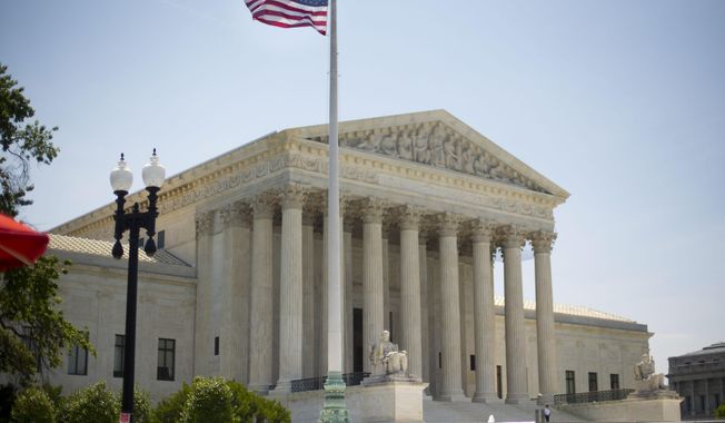 The Supreme Court building in Washington, Monday, June 30, 2014, following various court decisions. The court ruled on birth control, union fees and other cases. (AP Photo/Pablo Martinez Monsivais)
