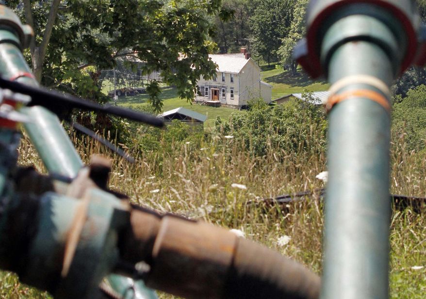FILE - This July 27, 2011 file photo shows a farmhouse in the background framed by pipes connecting pumps where the hydraulic fracturing process in the Marcellus Shale layer to release natural gas was underway at a Range Resources site in Claysville, Pa. In Pennsylvania’s fracking boom, new and more unconventional wells leaked far more than older and traditional wells, according to a study of inspections of more than 41,000 wells drilled. And that means that that methane leaks could be a problem for drilling across the nation, said the author of the study, which funded in part by environmental activist groups and criticized by the energy industry. The study was published Monday by the Proceedings of the National Academy of Sciences. (AP Photo/Keith Srakocic, File)