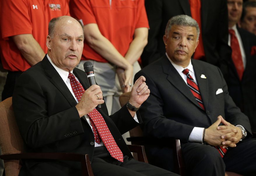 **FILE** Big Ten Commissioner James Delany, left, speaks at a news conference to announce the University of Maryland's decision to move to the Big Ten in College Park, Md., Monday, Nov. 19, 2012. Seated alongside Delany is Maryland athletic director Kevin Anderson.  (AP Photo/Patrick Semansky)