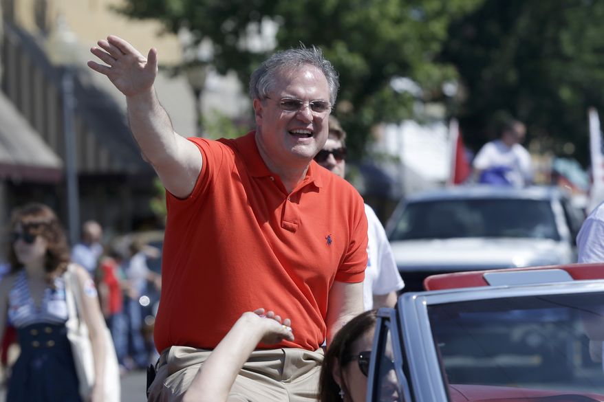 **FILE** Sen. Mark Pryor, Arkansas Democrat, rides in the the Pink Tomato Festival parade in Warren, Ark., on June 14, 2014. (Associated Press)