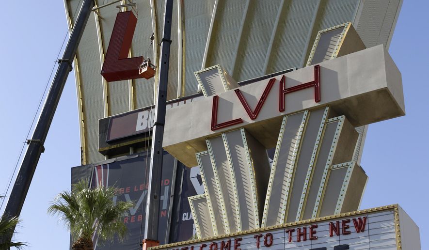 Construction workers lower part of the LVH sign Tuesday, July 1, 2014 in Las Vegas. Florida-based timeshare company Westgate Resorts announced it purchased the LVH hotel from Goldman Sachs and Gramercy Capital and would rename it Westgate Las Vegas Resort & Casino. Some of the nearly 3,000 rooms and suites will be converted to timeshare villas, while others will remain open to regular hotel guests. (AP Photo/John Locher)