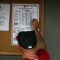 Washington Nationals manager Matt Williams (9) looks at the lineup in the dugout before a spring exhibition baseball game against the New York Mets, Wednesday, March 5, 2014, in Viera, Fla. (AP Photo/Alex Brandon)