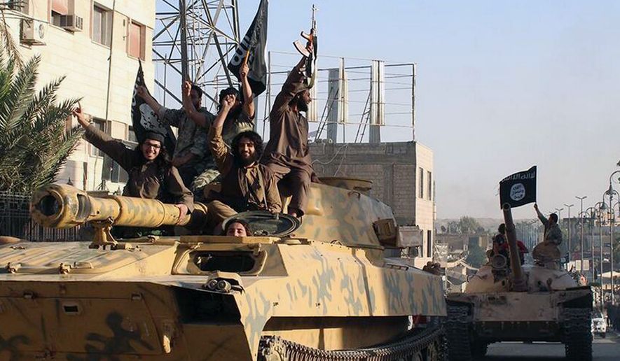 This undated image posted by the Raqqa Media Center, a Syrian opposition group, on Monday, June 30, 2014, which has been verified and is consistent with other AP reporting, shows fighters from the al Qaeda linked Islamic State of Iraq and the Levant (ISIL) during a parade in Raqqa, Syria. (AP Photo/Raqqa Media Center)