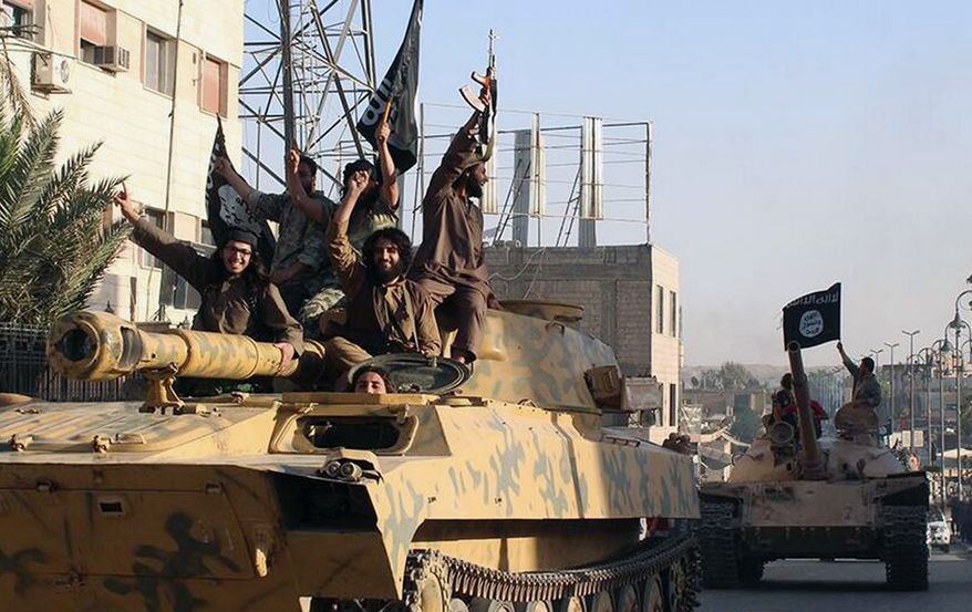 This undated image posted by the Raqqa Media Center, a Syrian opposition group, on Monday, June 30, 2014, which has been verified and is consistent with other AP reporting, shows fighters from the al Qaeda linked Islamic State of Iraq and the Levant (ISIL) during a parade in Raqqa, Syria. (AP Photo/Raqqa Media Center)