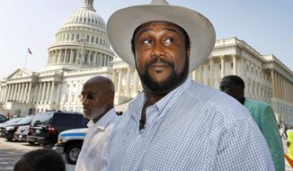 In this Sept. 23, 2010, file photo, John W. Boyd Jr., founder and president of the National Black Farmers Association, walks to a news conference on Capitol Hill in Washington. Boyd said he is owed $8 million for lobbying Congress to fund a $3.4 billion government settlement with Native American landowners who were swindled out of royalties. (AP Photo/Alex Brandon, File)