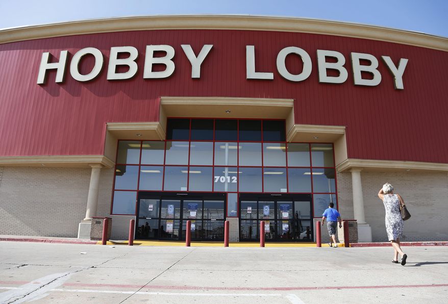 In this Monday, June 30, 2014, file photo, customers walk to a Hobby Lobby store in Oklahoma City. (AP Photo/Sue Ogrocki, File)