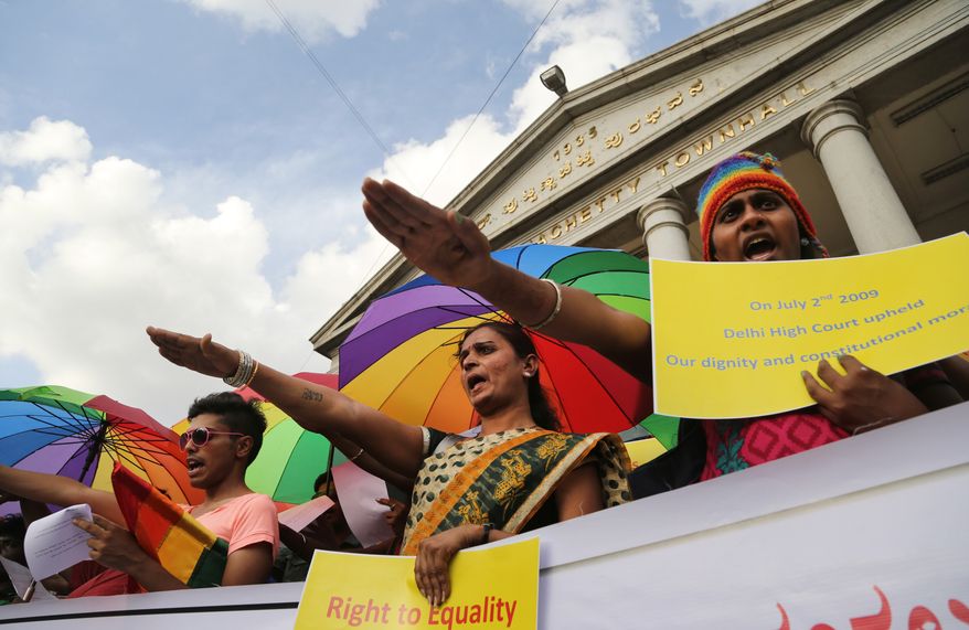 Gay-rights activists take oath to fight against inequality during a celebration marking the fifth anniversary of an Indian court's ruling decriminalizing homosexuality in India, in Bangalore, India, Wednesday, July 2, 2014. (AP Photo/Aijaz Rahi)