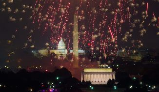 Fireworks can be seen from the Top of the Town as they explode over the National Mall to celebrate Independence Day, Arlington, Va., Wednesday, July 4, 2012. (Andrew Harnik/The Washington Times) (Andrew Harnik/The Washington Times)