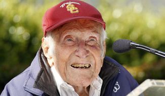 FILE - In a Friday May 9, 2014 file photo, Louis Zamperini gestures during a news conference, in Pasadena, Calif. Zamperini, a U.S. Olympic distance runner and World War II veteran who survived 47 days on a raft in the Pacific after his bomber crashed, then endured two years in Japanese prison camps, died Wednesday, July 2, 2014, according to Universal Pictures studio spokesman Michael Moses. He was 97. (AP Photo/Nick Ut, File)