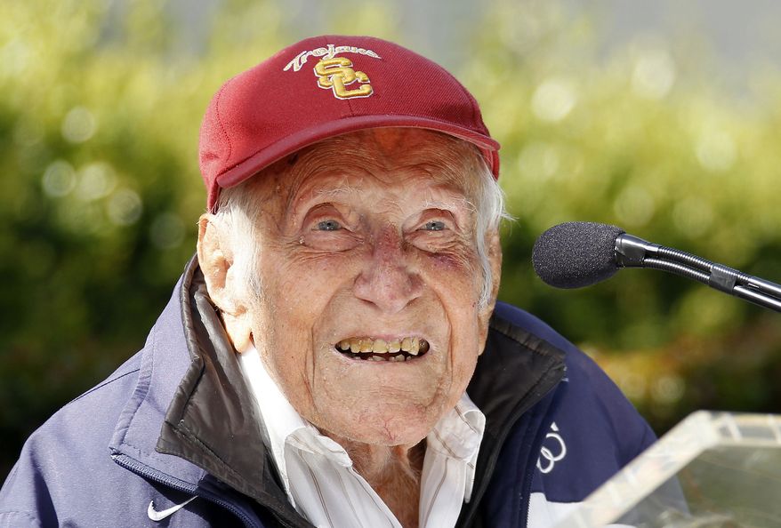 FILE - In a Friday May 9, 2014 file photo, Louis Zamperini gestures during a news conference, in Pasadena, Calif. Zamperini, a U.S. Olympic distance runner and World War II veteran who survived 47 days on a raft in the Pacific after his bomber crashed, then endured two years in Japanese prison camps, died Wednesday, July 2, 2014, according to Universal Pictures studio spokesman Michael Moses. He was 97. (AP Photo/Nick Ut, File)