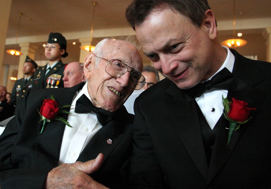 FILE - In this May 10, 2008 file photo provided by the National Ethnic Coalition, 91-year-old World War II veteran and member of the U.S. Olympic team during the 1936 Berlin Olympics Louis Zamperini, left, shares a moment with actor and founder of "Operation Iraqi Children" Gary Sinise before the start of the 2008 Ellis Island Medals of Honor ceremony on Ellis Island. Zamperini, a U.S. Olympic distance runner and World War II veteran who survived 47 days on a raft in the Pacific after his bomber crashed, then endured two years in Japanese prison camps, died Wednesday, July 2, 2014, according to Universal Pictures studio spokesman Michael Moses. He was 97. (AP Photo/National Ethnic Coalition, Tina Fineberg, File)