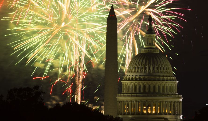 Fireworks illuminate the sky over the U.S. Capitol building and the Washington Monument during Fourth of July celebrations, on Friday, July 4, 2014, in Washington. (AP Photo/ Evan Vucci)  