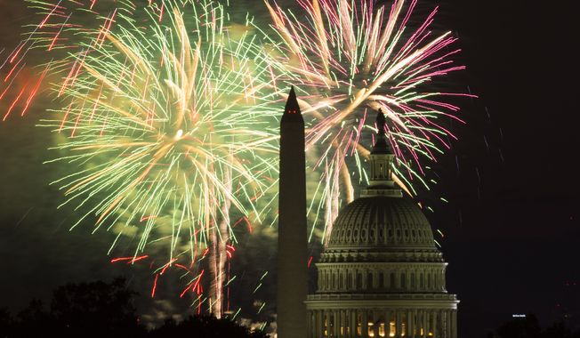 Fireworks illuminate the sky over the U.S. Capitol building and the Washington Monument during Fourth of July celebrations, on Friday, July 4, 2014, in Washington. (AP Photo/Evan Vucci)  