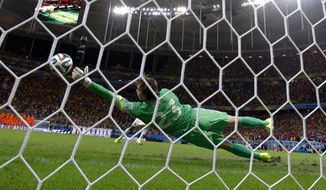 Netherlands&#x27; goalkeeper Tim Krul makes a save on a shot by Costa Rica&#x27;s Michael Umana during a penalty shootout in extra time during the World Cup quarterfinal soccer match at the Arena Fonte Nova in Salvador, Brazil, Saturday, July 5, 2014. The Netherlands defeated Costa Rica 4-3 in penalties after a 0-0 tie. (AP Photo/Wong Maye-E)