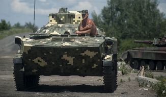 A Ukrainian paratrooper sits in an APC at a checkpoint near Slovyansk, eastern Ukraine, Saturday, July 5, 2014. Ukraine&#x27;s forces claimed a significant success against pro-Russian insurgents on Saturday, chasing them from one of their strongholds in the embattled east of the country. Rebels fleeing from the city of Slovyansk vowed to regroup elsewhere and fight on.  (AP Photo/Evgeniy Maloletka)