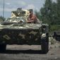 A Ukrainian paratrooper sits in an APC at a checkpoint near Slovyansk, eastern Ukraine, Saturday, July 5, 2014. Ukraine&#39;s forces claimed a significant success against pro-Russian insurgents on Saturday, chasing them from one of their strongholds in the embattled east of the country. Rebels fleeing from the city of Slovyansk vowed to regroup elsewhere and fight on.  (AP Photo/Evgeniy Maloletka)
