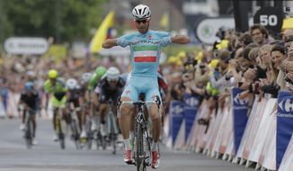 Italy&#39;s Vincenzo Nibali points to his shirt as he crosses the finish line ahead of the sprinting pack to win the second stage of the Tour de France cycling race over 201 kilometers (124.9 miles) with start in York and finish in Sheffield, England, Sunday, July 6, 2014. (AP Photo/Laurent Cipriani)