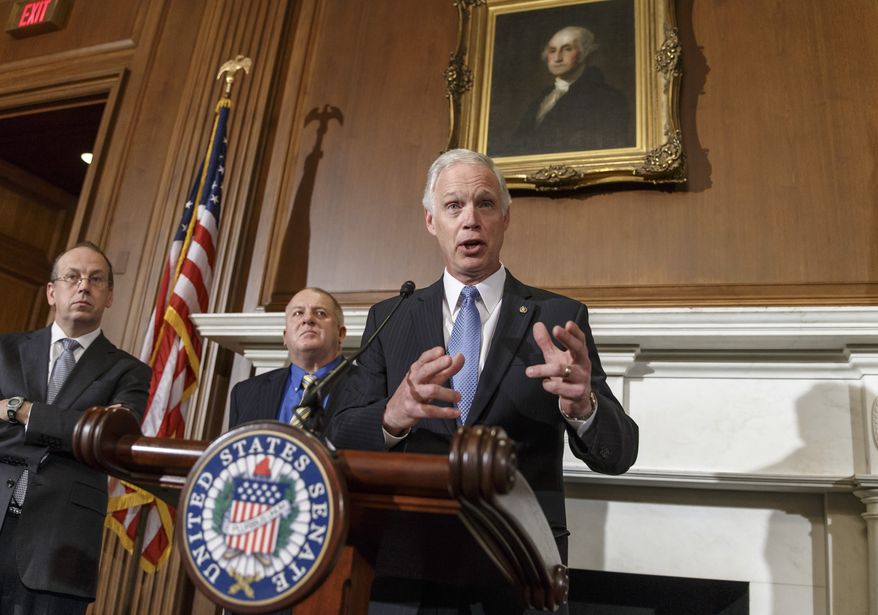** FILE ** In this Jan. 6, 2014, file photo, Sen. Ron Johnson, R-Wis., joined by attorneys Paul D. Clement, far left, and Rick Esenberg, second from left, announces that he has filed a lawsuit to block the federal government from helping to pay for health care coverage for members of Congress and their staffs during a news conference on Capitol Hill in Washington. A federal judge will hear arguments this week on whether to toss a U.S. senator's lawsuit challenging rules that force congressional members and their staffs to obtain government-subsidized health insurance through small business exchanges. (AP Photo/J. Scott Applewhite, File)