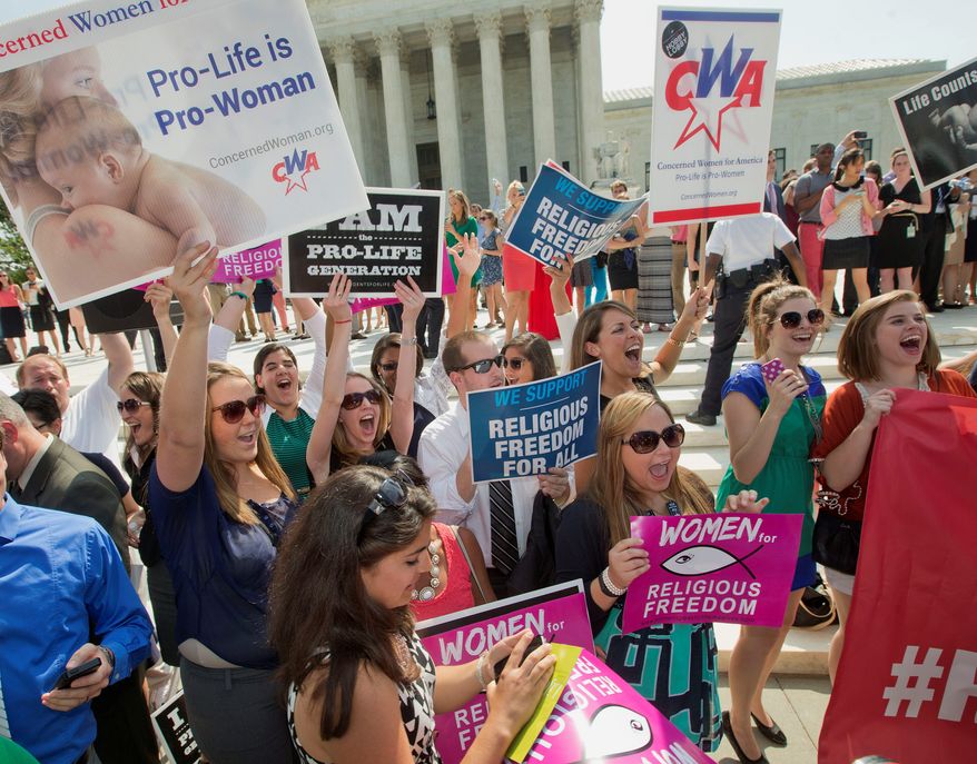 ** FILE ** Demonstrator react to hearing the Supreme Court's decision on the Hobby Lobby case outside the Supreme Court in Washington. The Supreme Court ruled that corporations can hold religious objections that allow them to opt out of the new health law requirement that employee insurance plans cover contraceptives for women. (Associated Press)