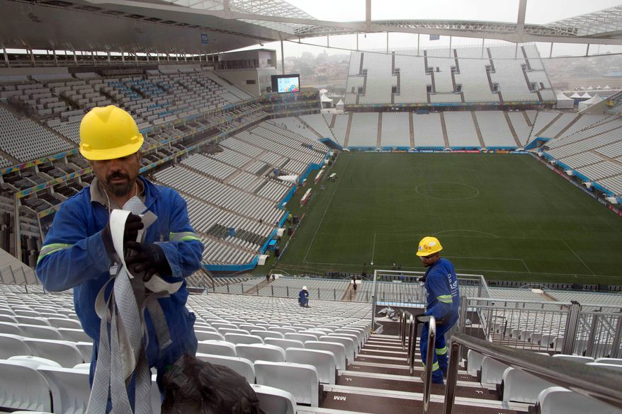 Workers clean the stairs at Arena Corinthians in Sao Paulo. Brazil faces a shortage of up to 8.5 million workers in 2020 if it hopes to maintain current growth rates, according to a report from the Boston Consulting Group. The United States is forecast to have a surplus of up to 22 million workers in 2020. (Associated Press)