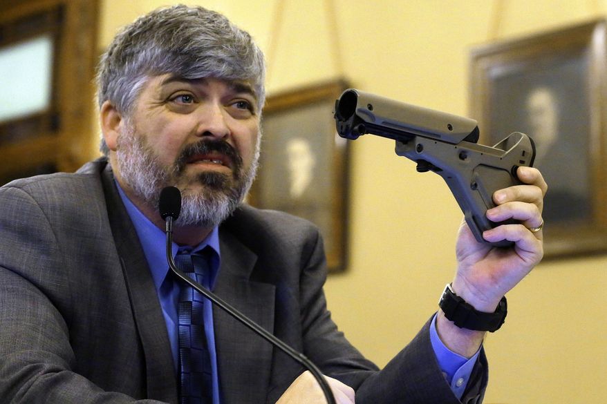 **FILE** Todd Vandermyde with the NRA shows off a gun butt stock during a House Committee hearing on assault weapons at the Illinois State Capitol in Springfield in February 2013. (Associated Press)