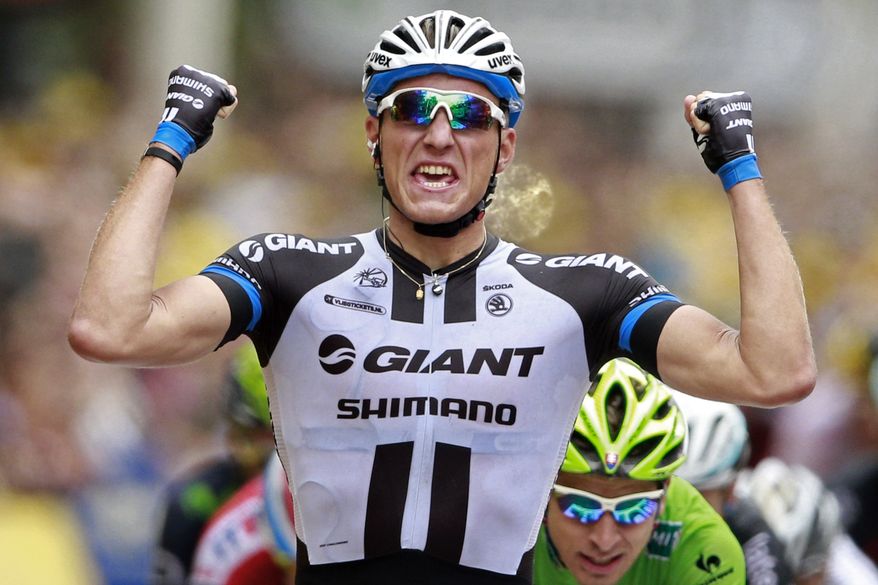 Germany&#x27;s sprinter Marcel Kittel crosses the finish line ahead of celebrates on the podiums, bottom right, to win the third stage of the Tour de France cycling race over 155 kilometers (96.3 miles) with start in Cambridge and finish in London, England, Monday, July 7, 2014. (AP Photo/Peter Dejong)