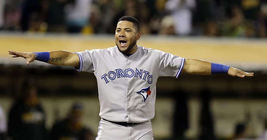 Toronto Blue Jays' Melky Cabrera signals he is safe after being called out at home plate in the eighth inning of a baseball game against the Oakland Athletics Saturday, July 5, 2014, in Oakland, Calif. A review of the play confirmed Cabrera was out. (AP Photo/Ben Margot)