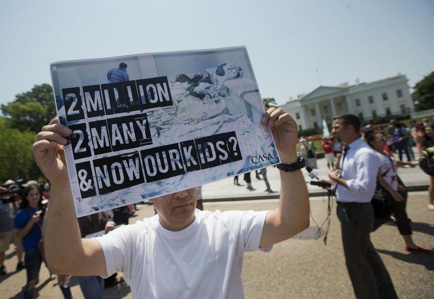 A demonstrator holds up a signs outside the White House in Washington, Monday, July 7, 2014, following a news conference of immigrant families and children's advocates responding to the President Barack Obama's response to the crisis of unaccompanied children and families illegally entering the US. A top Obama administration official says no one, not even children trying to escape violent countries, can illegally enter the United States without eventually facing deportation proceedings. But Homeland Security Sec Jeh Johnson basically acknowledged Sunday that such proceedings might be long delayed, and he said that coping with floods of unaccompanied minors crossing the border is a legal and humanitarian dilemma for the US. (AP Photo/Pablo Martinez Monsivais)