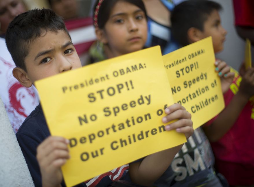 From left, Raul Amador Sanchez, 7, from Georgia, Alexandra Diaz, 9, and her brother Andy Diaz, 7, both from Baltimore, Md., hold up signs as they join their parent during a news conference of immigrant families and children’s advocates responding to the President Barack Obama’s response to the crisis of unaccompanied children and families illegally entering the US, Monday, July 7, 2014, on the steps of St. John's Church in Washington. A top Obama administration official says no one, not even children trying to escape violent countries, can illegally enter the United States without eventually facing deportation proceedings. But Homeland Security Sec Jeh Johnson basically acknowledged Sunday that such proceedings might be long delayed, and he said that coping with floods of unaccompanied minors crossing the border is a legal and humanitarian dilemma for the US. (AP Photo/Pablo Martinez Monsivais)