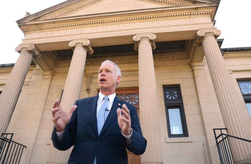 U.S. Sen. Ron Johnson holds a news conference on the steps of Wisconsin Eastern District Federal Courthouse Monday, July 7, 2014 in Green Bay, Wis. A government attorney is trying to persuade a federal judge in Green Bay to toss out Johnson's lawsuit challenging rules forcing congressional members and their employees to seek government-subsidized health insurance through small business exchanges. U.S. Justice Department attorney James Luh told U.S. District Judge William Griesbach on Monday that Johnson can't sue because he hasn't shown how the rules have caused him any injury. (AP Photo/The Green Bay Press-Gazette, Jim Matthews) NO SALES