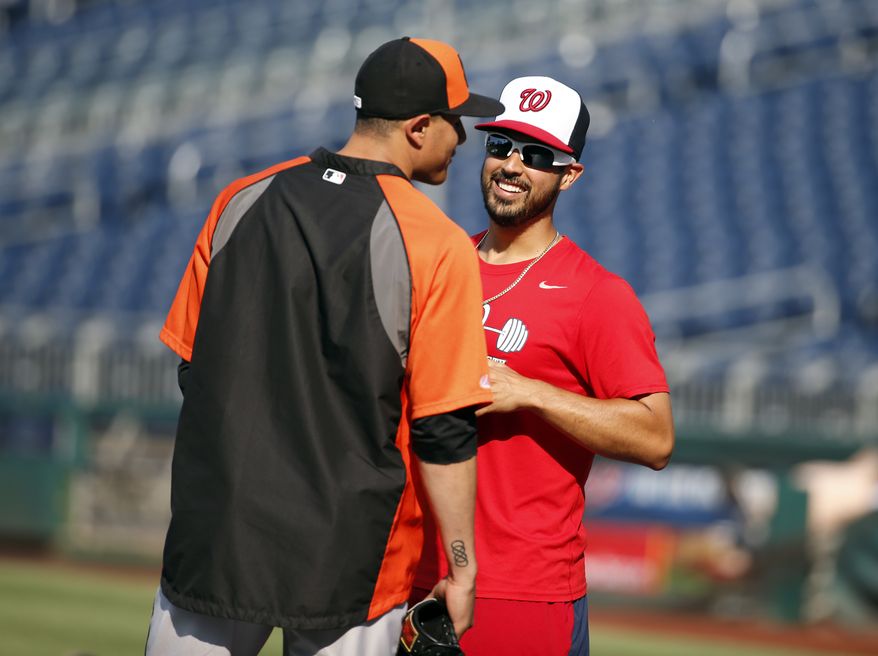Baltimore Orioles third baseman Manny Machado, left, talks with Washington Nationals starting pitcher Gio Gonzalez before an interleague baseball game at Nationals Park, Monday, July 7, 2014, in Washington. (AP Photo/Alex Brandon)