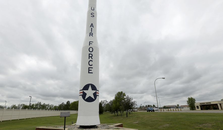 ** FOR TRANSMISSION AFTER 1AM, WEDNESDAY, JULY 9, 2014 ** In this photo taken June 25, 2014, a retired Minuteman 1 missile stands at the main entrance to Minot Air Force Base, N.D. The Minuteman 1 was replaced by the Minuteman 3 by 1971 which now form the foundation of the US nuclear defense strategy. (AP Photo/Charlie Riedel)