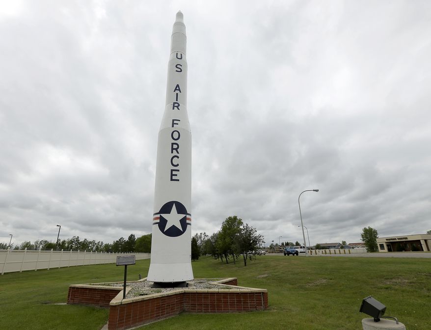 ** FOR TRANSMISSION AFTER 1AM, WEDNESDAY, JULY 9, 2014 ** In this photo taken June 25, 2014, a retired Minuteman 1 missile stands at the main entrance to Minot Air Force Base, N.D. The Minuteman 1 was replaced by the Minuteman 3 by 1971 which now form the foundation of the US nuclear defense strategy. (AP Photo/Charlie Riedel)