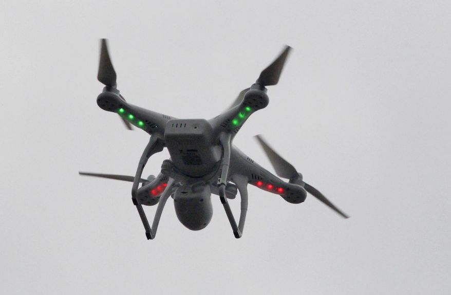 ** FILE ** This March 12, 2014, file photo shows a drone flown by Brian Wilson, landing after flying over the scene of an explosion that leveled two apartment buildings in the East Harlem neighborhood of New York. Even though it's illegal to fly the devices just about anywhere in New York City without permission, the incidents and breathtaking videos of Manhattan's steel-and-glass canyons and sweeping skyline photos suggest that the restrictions are being widely flouted. (AP Photo/Mark Lennihan, File)