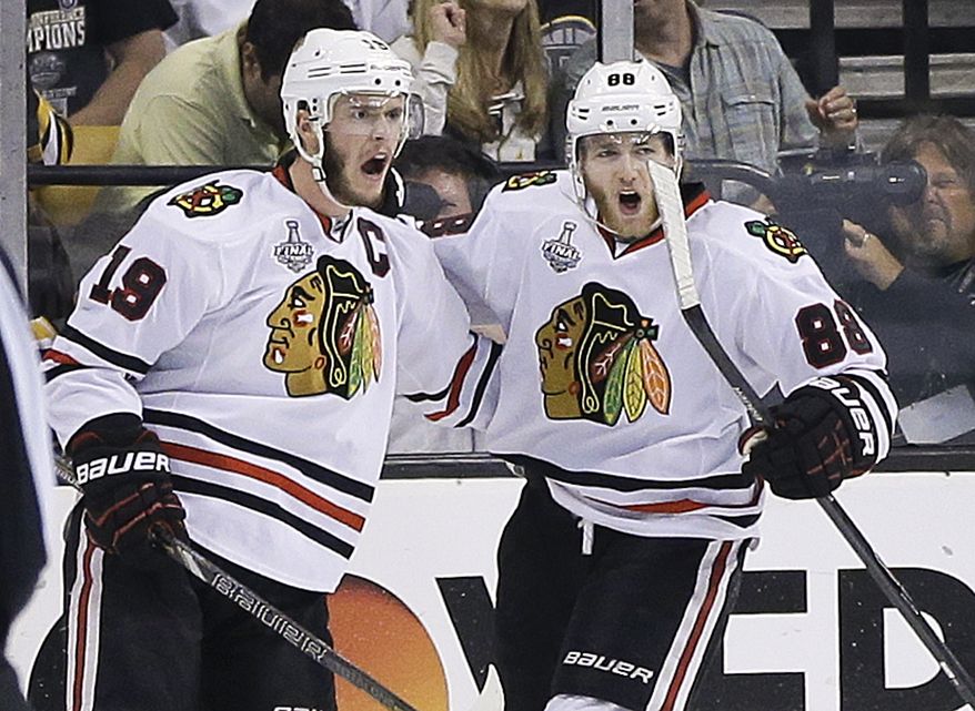 Chicago Blackhawks center Jonathan Toews (19) celebrates his goal with right wing Patrick Kane (88) during the second period in Game 6 of the NHL hockey Stanley Cup Finals against the Boston Bruins, Monday, June 24, 2013, in Boston. (AP Photo/Elise Amendola)