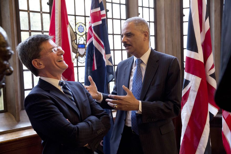 The U.S. Attorney General Eric Holder, right, jokes with New Zealand's Attorney General Chris Finlayson QC, as they chat after posing for a group photograph before an evening dinner in the Grand Hall of Gray's Inn in London, Wednesday, July 9, 2014. The Attorneys General from Australia, Britain, Canada, New Zealand and the U.S. are meeting in London for a conference July 9 to 11 to discuss emerging issues and existing trends in fighting international cybercrime. (AP Photo/Matt Dunham)